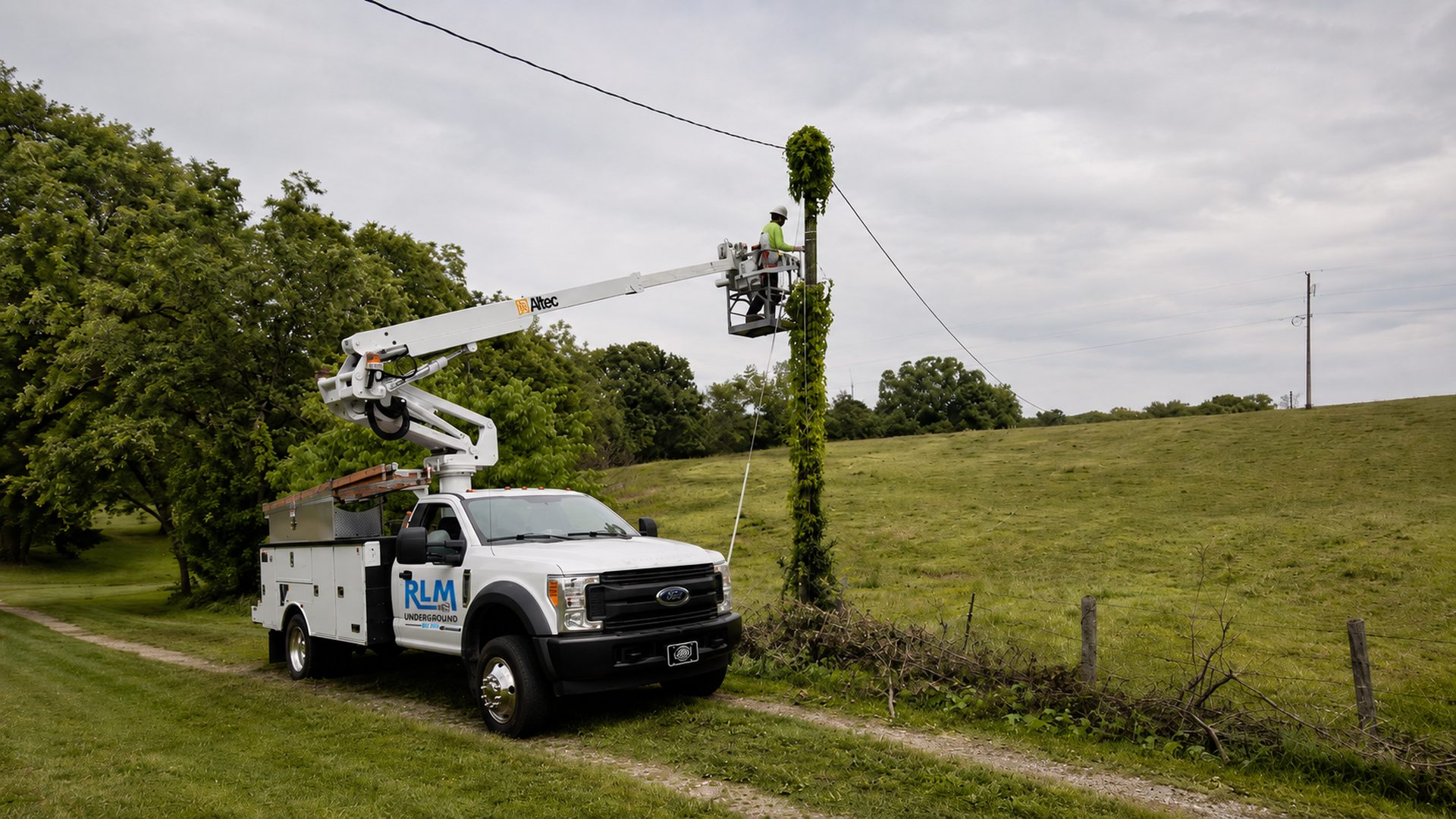 Lineman installing aerial fiber from a bucket truck